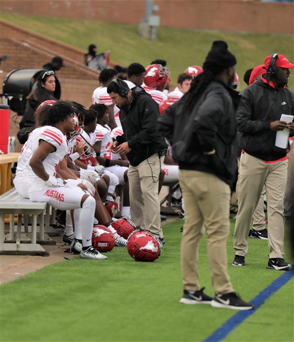 Group of players on bench getting coached